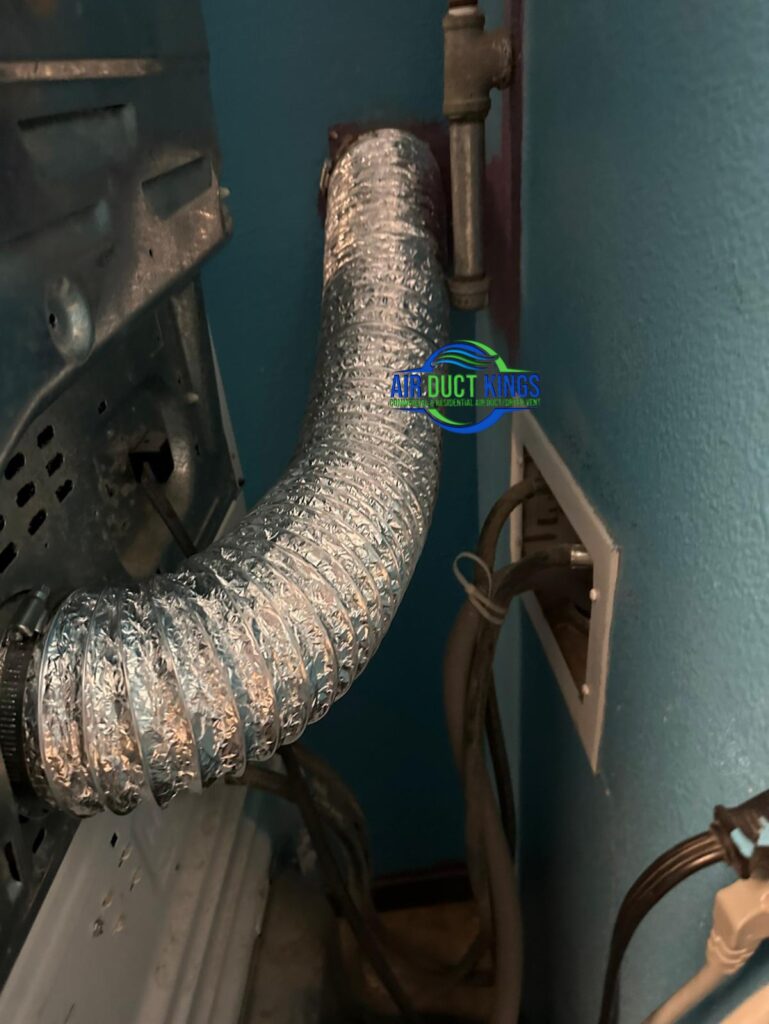 Old foil dryer duct before replacement in an Orange County laundry room