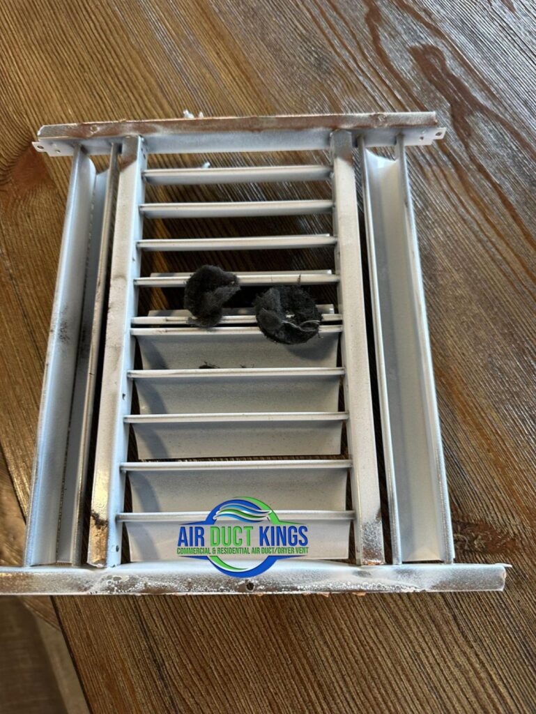 Dusty register removed during commercial duct cleaning