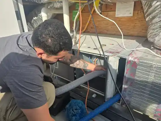 Contact Air Duct Kings technician cleaning an air handler in Orange County