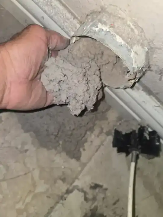 Clogged dryer vent packed with lint before cleaning in Orange County